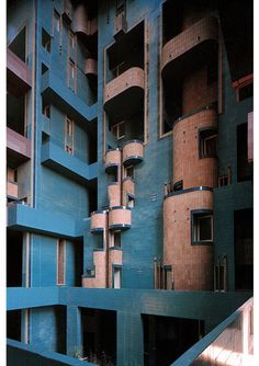 an unusual building with multiple balconies on the top and bottom floors is blue