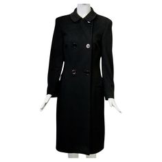 c.1990s Gianni Versace coat in soft 15% cashmere/wool blend, featuring a true double-breasted style that buttons up to a small round collar. The body of the coat has seams towards the front and back sides as well as darts in front that shape it to the body. Horizontal, bound pockets and set-in sleeves add to the clean lines of this coat. Bound buttonholes throughout. Black lining with Gianni Versace Couture label. Approximate size 6-8. Formal Winter Button-up Pea Coat, Formal Button-up Pea Coat For Winter, Double-breasted Wool Outerwear For Career, Fitted Double-breasted Wool Coat With Button Closure, Luxury Career Outerwear With Buttons, Elegant Winter Pea Coat With Button-up, Elegant Button-up Pea Coat For Winter, Formal Fitted Pea Coat With Button Cuffs, Fall Formal Pea Coat With Buttons