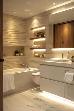 a bathroom with a sink, toilet and bathtub in the middle is illuminated by recessed lighting