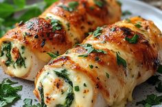 three pieces of food on a plate with parmesan cheese and spinach leaves