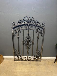 an ornate iron gate in the corner of a room