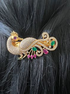 Hair Clip AD Ruby Emerald Stones  Gold Finish / Peacock Designer Hair Clip 2.8 inches Gold Jewelry /Gift Jewelry /South Indian Jewelry This cute hair accessory can be worn for any occasion.  Spring-loaded hair clip. Light-weight. Size: 2.8 inches  Weight: 0.90 oz (26 g) Material: Artificial gold Finish AD Ruby Emerald  Stones. Finish:  Gold finish. PRODUCT CARE: - Avoid contact with water and chemicals such as perfumes or any sprays to prevent product damage.  - Store wrapped in butter paper, cotton cloth, or the provided box. South Indian Hair Accessories, Hair Clips Gold, Indian Hair Accessories, Peacock Hair Clip, Butter Paper, Peacock Hair, Silk Thread Bangles Design, Thread Bangles Design, Peacock Jewelry