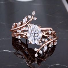 a close up view of a diamond ring on a marble surface