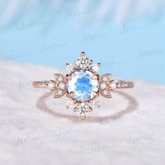 an engagement ring with a blue stone surrounded by diamonds