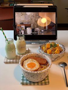 an image of food on the table with a computer screen in the backround