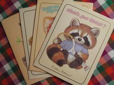 three children's greeting cards featuring a raccoon holding a tennis racket