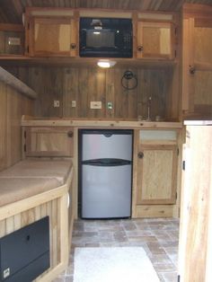 a kitchen with wooden cabinets and a refrigerator freezer next to a stove top oven