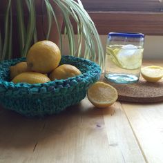 some lemons are sitting in a bowl on a table