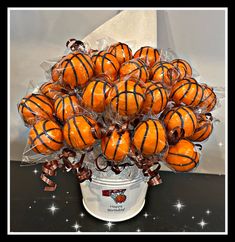 a basket filled with oranges wrapped in cellophane and sitting on top of a table