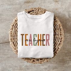 Custom Teacher Name T-shirt, Customized Kindergarten Dream Team Teacher T-Shirt, Personalized Kindergarten Teacher,Teacher Appreciation Gi ❀ FABRICS ❀ 1-100% Combed and Ring-Spun Cotton 2- Wrinkle-Resistant 3-Soft and Comfortable 4- Durable 5- Absorbs Moisture ❀DETAIL❀ For printing, we use Bella Canvas and Gildan SoftStyle brand shirts, which are the best in the industry. *Bella Canvas -unisex size -4.2 oz. -Solid colors are 100% Combed Cotton and Ring-Spun Cotton. -Athletic Heather 90% Combed and Ring-Spun Cotton, 10% Polyester -All Heather CVC Colors 52% Combed and Ring-Spun, 48% Polyester *Gildan SoftStyle -unisex size -Sport Gray : 4.5 oz/yd² | 90% Ring Cotton / 10% Polyester -Heather Navy, Heather Maroon, Heather Galapagos Blue, Dark Heather : 4.5 oz/yd² | 65% Polyester / 35% Ring Cot Teacher Appreciation Short Sleeve T-shirt With Letter Print, Personalized Teacher Appreciation T-shirt For Back To School, Short Sleeve T-shirt With Name Print For Teacher Appreciation, Teacher Name, Kindergarten Teachers, Teacher Tshirts, Branded Shirts, Teacher Appreciation Gifts, Dream Team