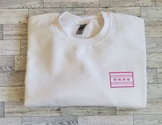 "Variation of Chicago Flag - embroidered in pink and white on a white crewneck adult sized sweatshirt. Gildan sweatshirt in white as shown in pictures.   Made to order. Design measures approximately 3\" x 2\" Exact placement may vary slightly Sweatshirts are 50/50 cotton/polyester blend Care: Machine wash cold on gentle cycle Do not bleach or use fabric softener Air dry or tumble dry on low heat Do not dry clean" Chicago Flag, Order Design, Gildan Sweatshirt, White Crewneck, Sweatshirt White, Gildan Sweatshirts, Fabric Softener, White Sweatshirt, Chicago Il