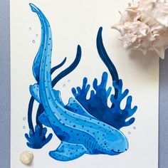 an image of a blue sea animal with corals on the table next to it