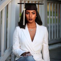 a woman wearing a graduation cap and jeans