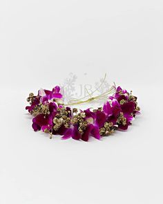 a purple flower headband is shown on a white background with the word love spelled in gold