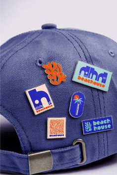 a blue hat with various stickers attached to it's brim and visor