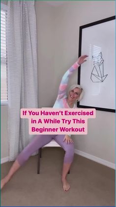 a woman in purple pants and pink shirt doing yoga