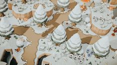 there are many cakes on the table with white frosting