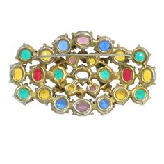 1920s Czech gilded jewel-tone crystal brooch. Oval open-work design set with open-back chaton-cut crystals in hues of sapphire, ruby, emerald, amethyst, & citrine; a slightly raised center embellished w/ small gilded leaves. The saturated colors of the stones make a vivid statement; the effect reproduces the thrill of stained glass. A rich & resonant example of Czech artistry at its finest. 1920s Jewelry, Ruby Emerald, Work Design, Crystal Brooch, Saturated Color, Design Set, Jewel Tones, Citrine, Brooches