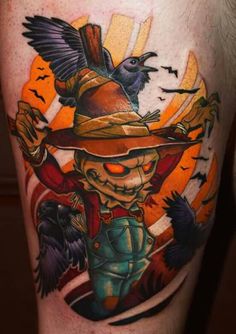 a tattoo on the leg of a man with a bird flying over him and an orange sun