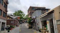 an alley way with buildings and shops on both sides