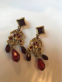 Elegant Red Crystal Goldtone Chandelier Dangling Earrings These gorgeous pierced earrings are nice matte gold tone with deep red sparkling crystals. They are Just over 2 inches long. In excellent recent 90's vintage condition. I will add new fresh backs. & gift nicely 🎀 www.MySoulRepair.com Red Chandelier Earrings For Formal Events, Formal Red Chandelier Earrings, Red Jeweled Earrings For Evening, Red Vintage Dangle Chandelier Earrings, Vintage Red Dangle Chandelier Earrings, Red Vintage Chandelier Dangle Earrings, Ornate Red Earrings For Party, Formal Red Dangle Clip-on Earrings, Red Dangle Clip-on Earrings For Formal Occasions