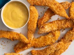 fried fish sticks on a plate with dipping sauce