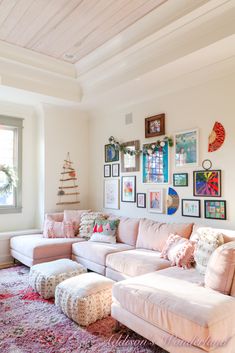 a living room filled with lots of furniture and pictures on the wall above it's couch