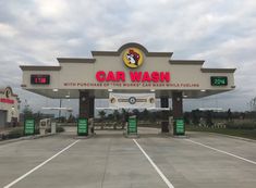 a car wash sign in front of a gas station