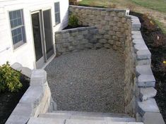 an outdoor patio with stone steps leading up to the back door and side yard area