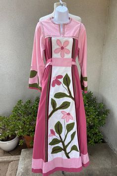 "Vintage bohemian custom made kaftan long dress pinks greens floral applications XS. Made of possible fabric cotton and polyester blend, no labels . angel sleeves, tie high waist. Good condition but has fade on shoulders, a couple mild spots in last 3 photos. Weight of dress 2 pounds Measurements Shoulders 15\" Sleeves 22\" Bust 36\" High Waist 34\" Waist 36\" Hips 46\" Length 57\"" Fitted Long Pink Kaftan, Pink Embroidered Long Sleeve Maxi Dress, Pink Long Sleeve Embroidered Maxi Dress, Pink Floral Embroidery Floor-length Maxi Dress, Embroidered Maxi Length Pink Kaftan, Embroidered Pink Maxi Kaftan, Pink Embroidered Maxi Kaftan, Pink Embroidered Maxi-length Kaftan, Pink Embroidered Maxi Length Kaftan