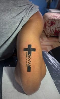 a person with a cross tattoo on their leg