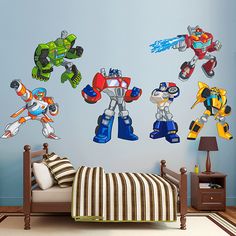 a bedroom with a bed and wall decals on the walls that say, transformers rescue bots united