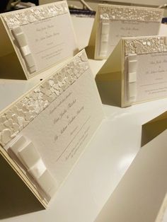 wedding stationery in ivory and white with matching pocketfolds for the bride's guests