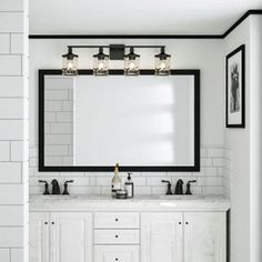 a bathroom with two sinks and a large mirror on the wall above them is shown