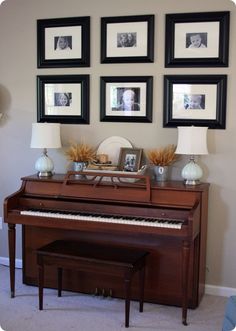 a living room with a piano and pictures on the wall