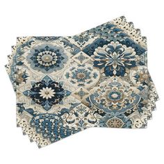 two pieces of blue and white rugs on top of each other with different designs