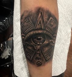 an all seeing eye tattoo on the arm