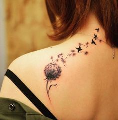 a woman with a dandelion tattoo on her back