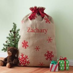 a christmas sack with a teddy bear next to it