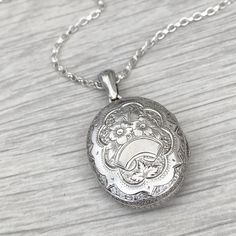 Pre - Owned Vintage British Jewellery  Vintage silver large oval engraved locket pendant  Locket size - 32mm x 25mm ( with bail 45mm in length) A new silver 2.2mm wide trace 28 inch chain (can be shortened) Locket and chain weight - 14.58g Not hallmarked or stamped  Condition - Great condition. This item comes in a lovely branded gift box Part of this item is second hand so the condition is not 100% perfect as you would expect from a brand new item! It has however been cleaned and refinished to Engraved White Gold Pendant Locket Necklace, Antique Silver Locket Necklace With Oval Pendant, Antique Silver Oval Pendant Locket Necklace, Antique Silver Oval Pendant Necklace With Locket, Antique Silver Necklace With Oval Locket Pendant, Engraved White Gold Sterling Silver Locket Necklace, Engraved Silver Locket Necklace Keepsake, Engraved Silver Locket Necklace For Keepsake, Oval White Gold Locket Necklace