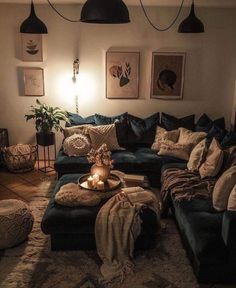 a living room filled with lots of furniture next to a wall mounted light and pictures on the wall