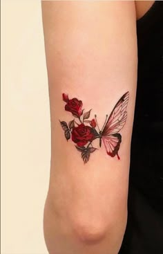 a woman with a tattoo on her arm has a butterfly and roses tattooed on it