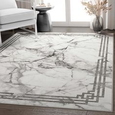 a white and gray area rug in a living room