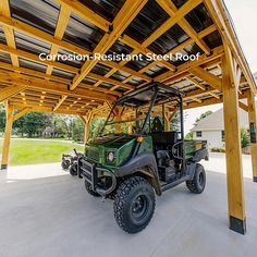 a green utility vehicle parked under a wooden structure