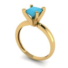 a gold ring with a blue stone in the center and an arrow on the side