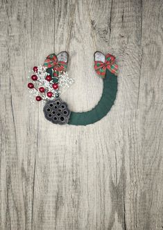 a christmas wreath hanging on the side of a wooden wall