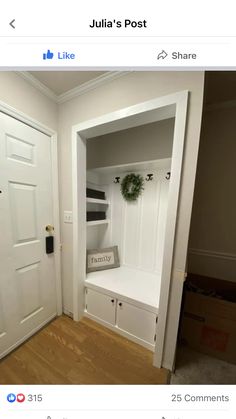 an empty room with a white door and some shelves in the corner that have books on them