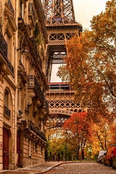 the eiffel tower towering over an old street in paris, france during autumn