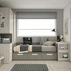 a bedroom with a bed, desk and shelves in it's corner area next to a window