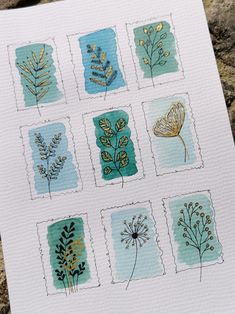 a card with different types of plants on it and some watercolor paper in the background